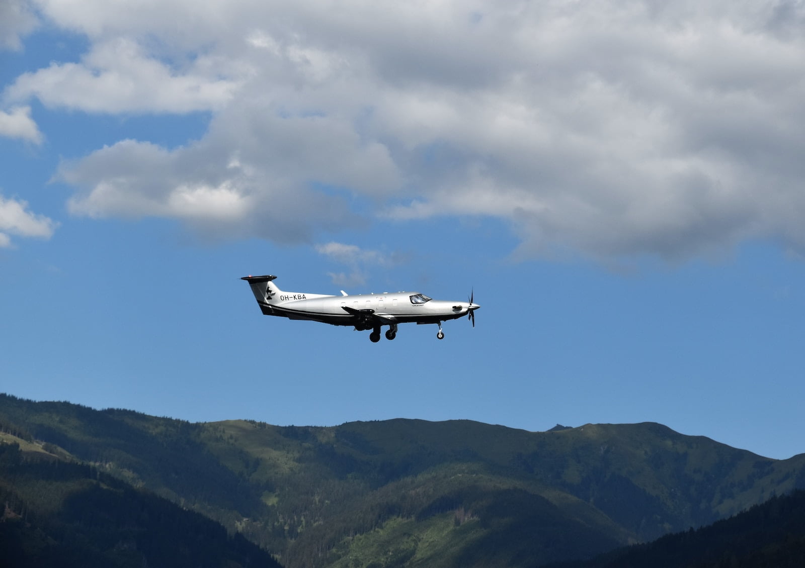 an airplane flying over a mountain